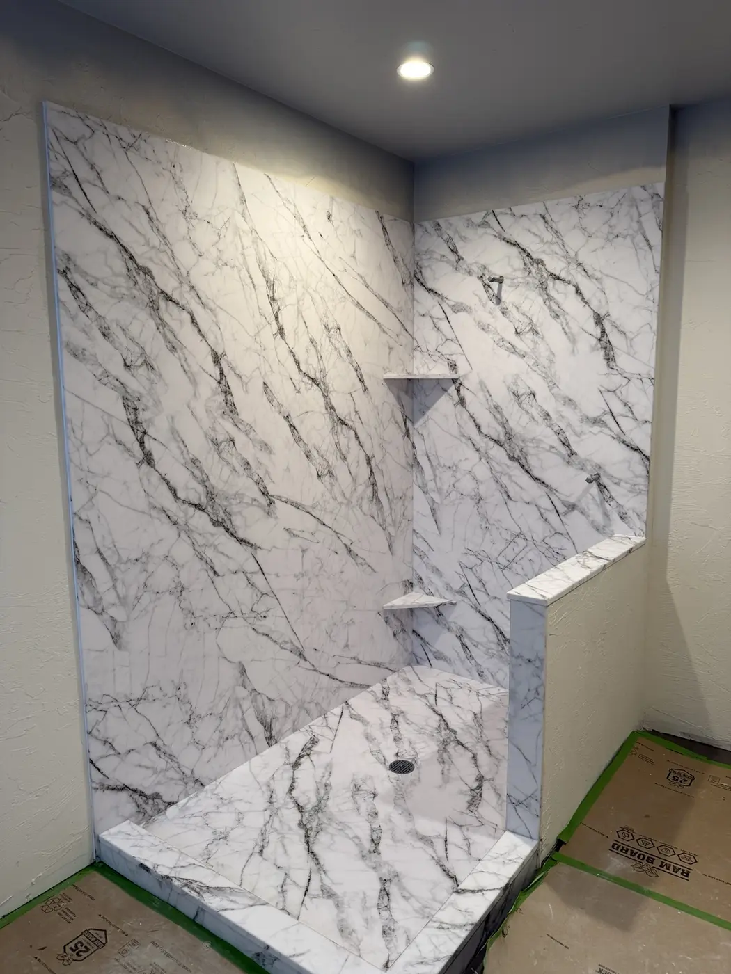 Custom blue-veined cultured marble walk-in shower