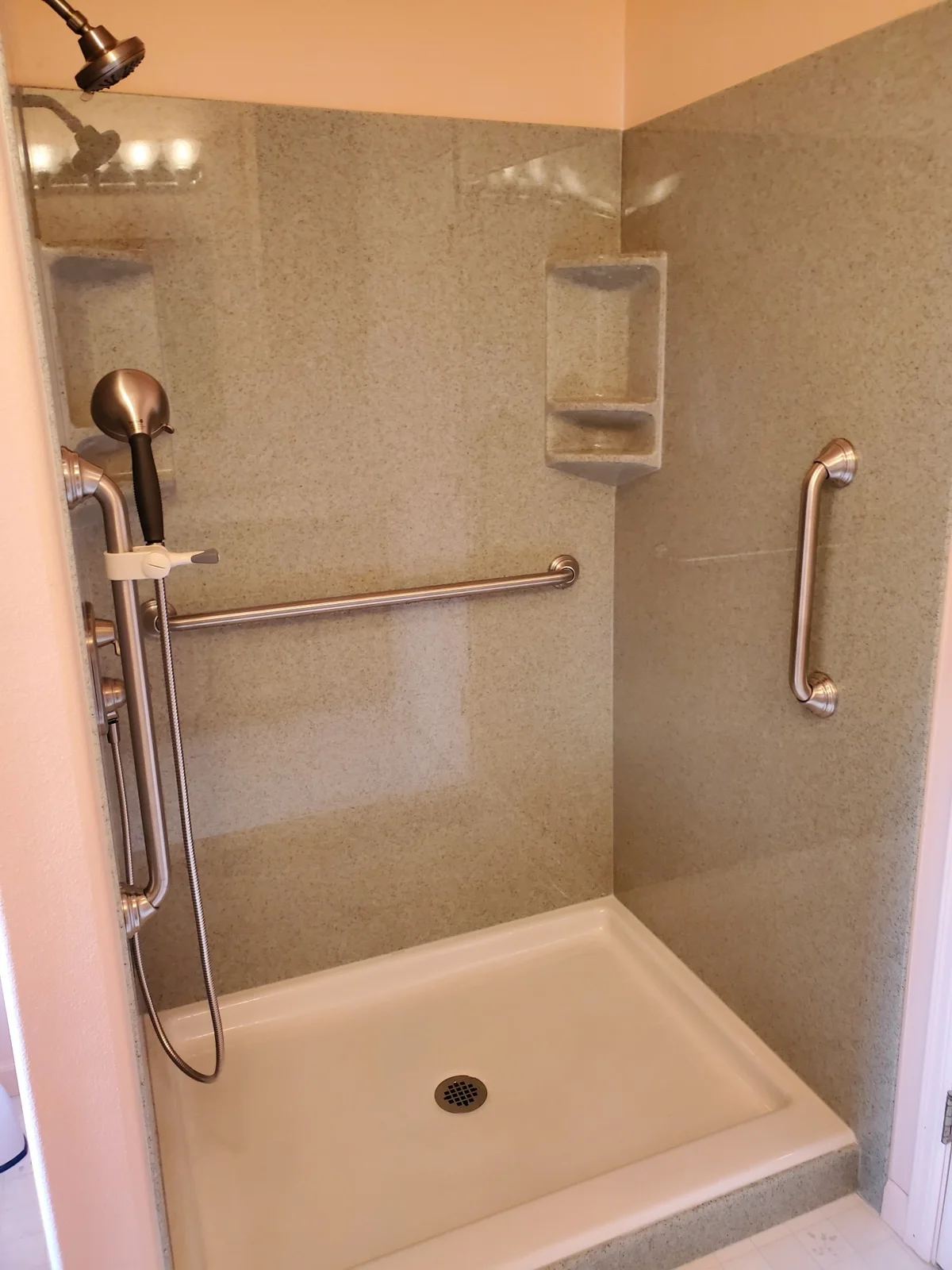 Shower with grab bars and corner shelves