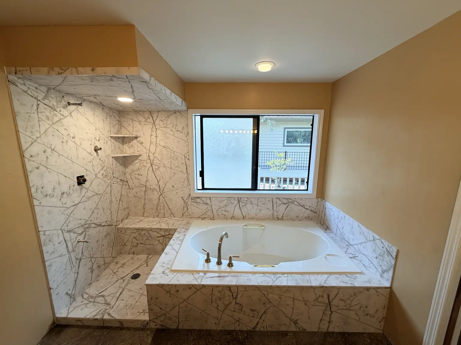 Cultured marble shower and soaking tub surround