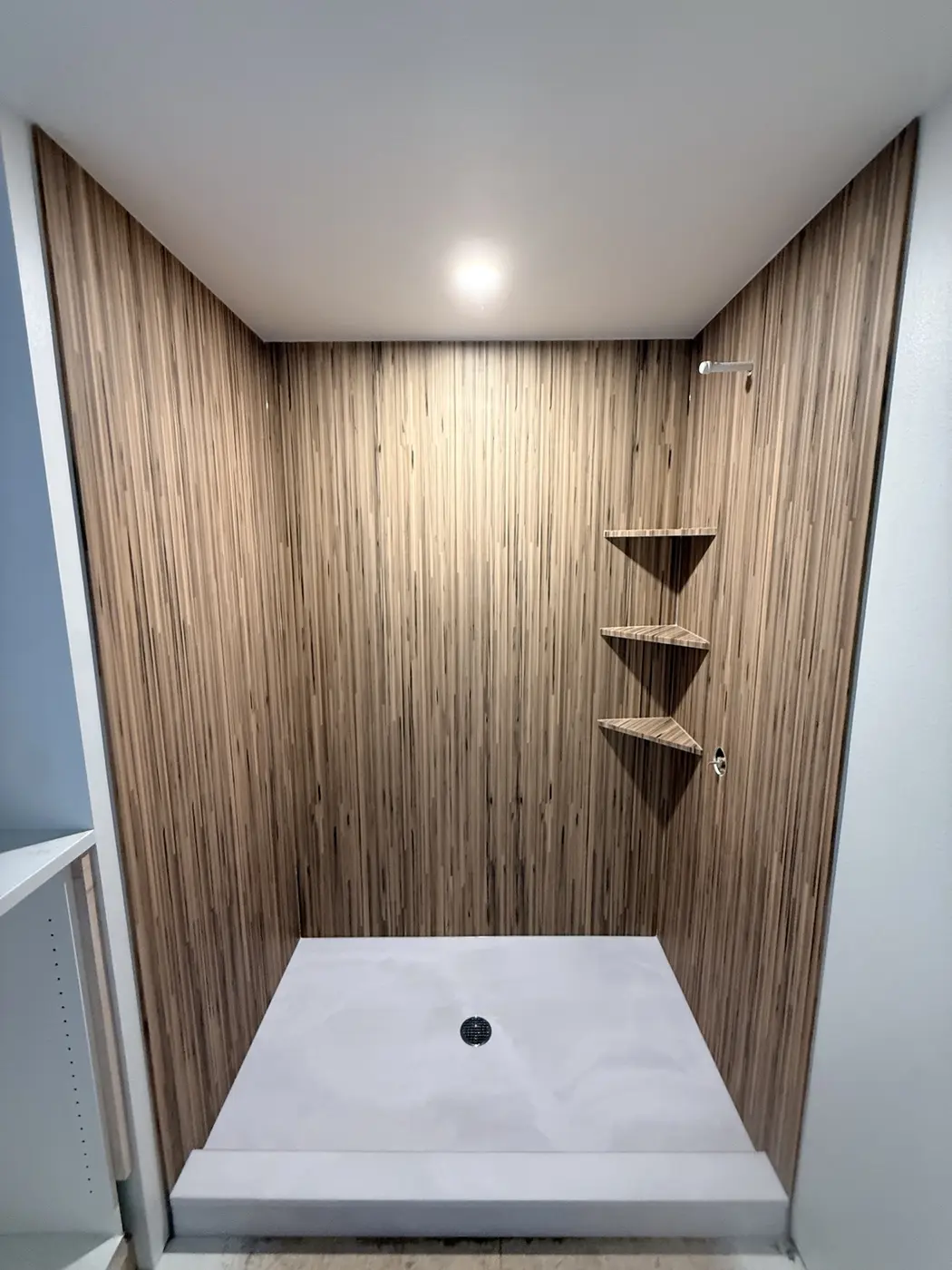 Warm woodgrain patterned cultured marble shower